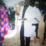 Robert Macharia with a trophy